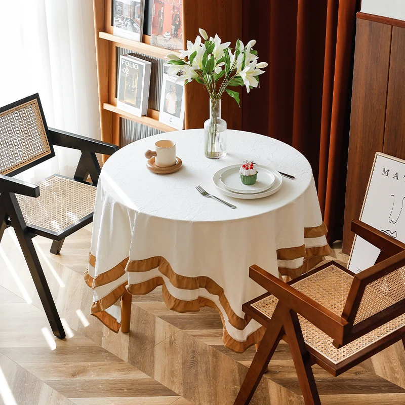 Round tablecloth with quilted textured relief and double-layered ruffle Stornfield