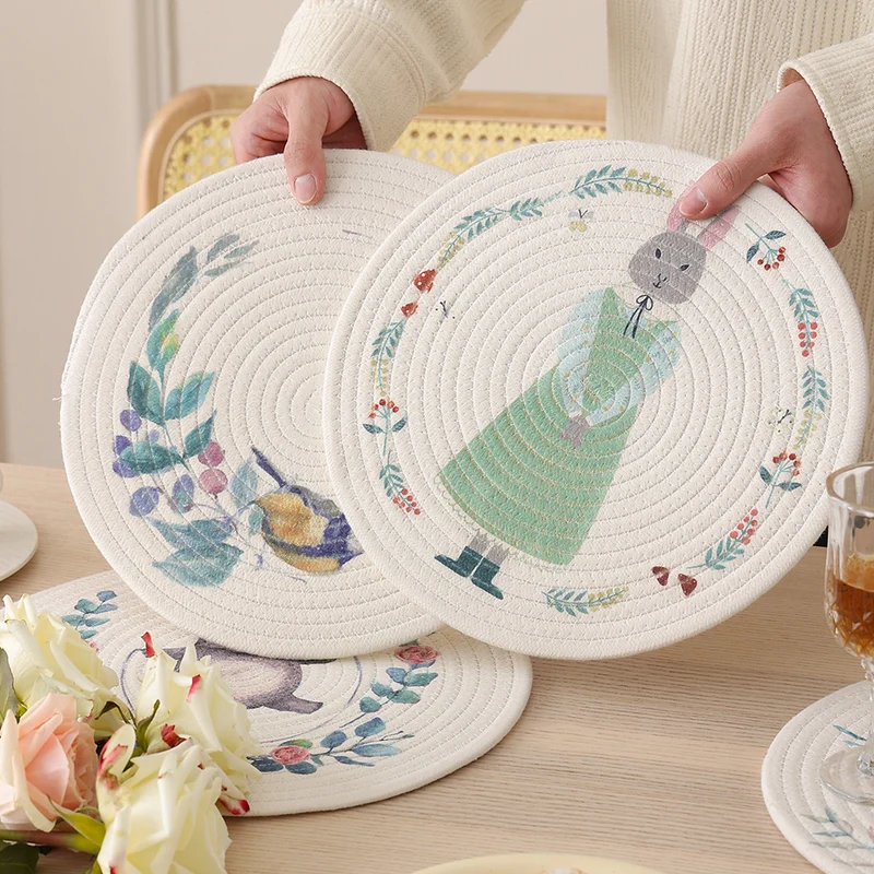 Round placemat made of woven cotton with a cute rhinoceros illustration and floral wreath Stornfield