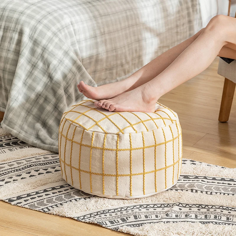 Round seat pouf with knitted check cover and shape-stable inner core Stornfield
