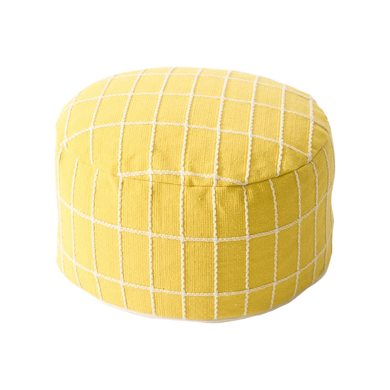 Round seat pouf with knitted check cover and shape-stable inner core Stornfield
