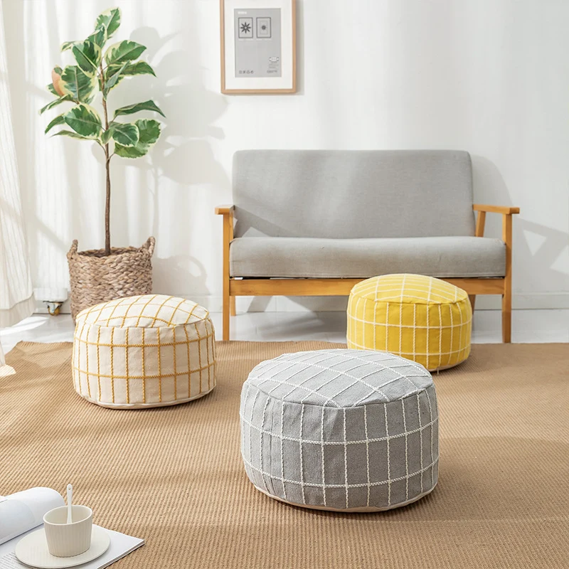 Round seat pouf with knitted check cover and shape-stable inner core Stornfield