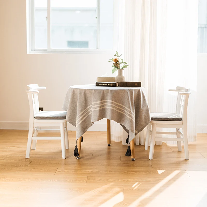 Rectangular linen look tablecloth with fringed tassels and side stripe border design Stornfield