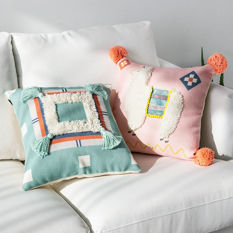 Square cushion cover with 3D alpaca appliqué, bouclé patch and pom-pom corners Stornfield