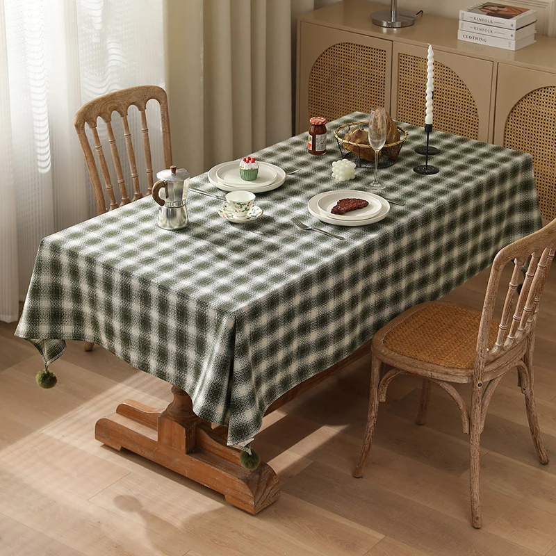 Square tablecloth made of cotton blend fabric with checkered weave pattern and pom-pom corners Stornfield