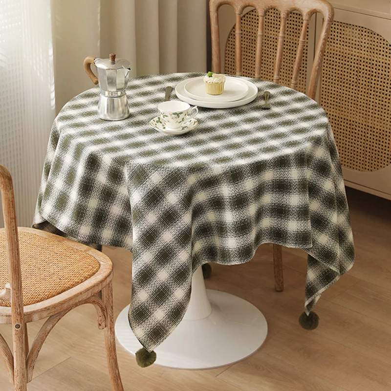 Square tablecloth made of cotton blend fabric with checkered weave pattern and pom-pom corners Stornfield