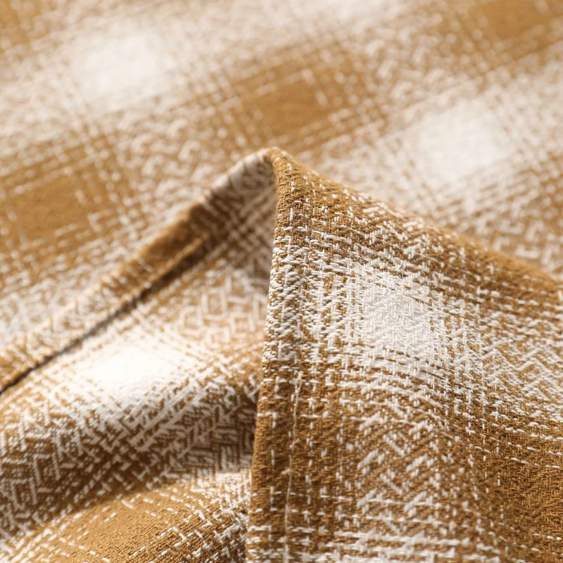Square tablecloth made of cotton blend fabric with checkered weave pattern and pom-pom corners Stornfield
