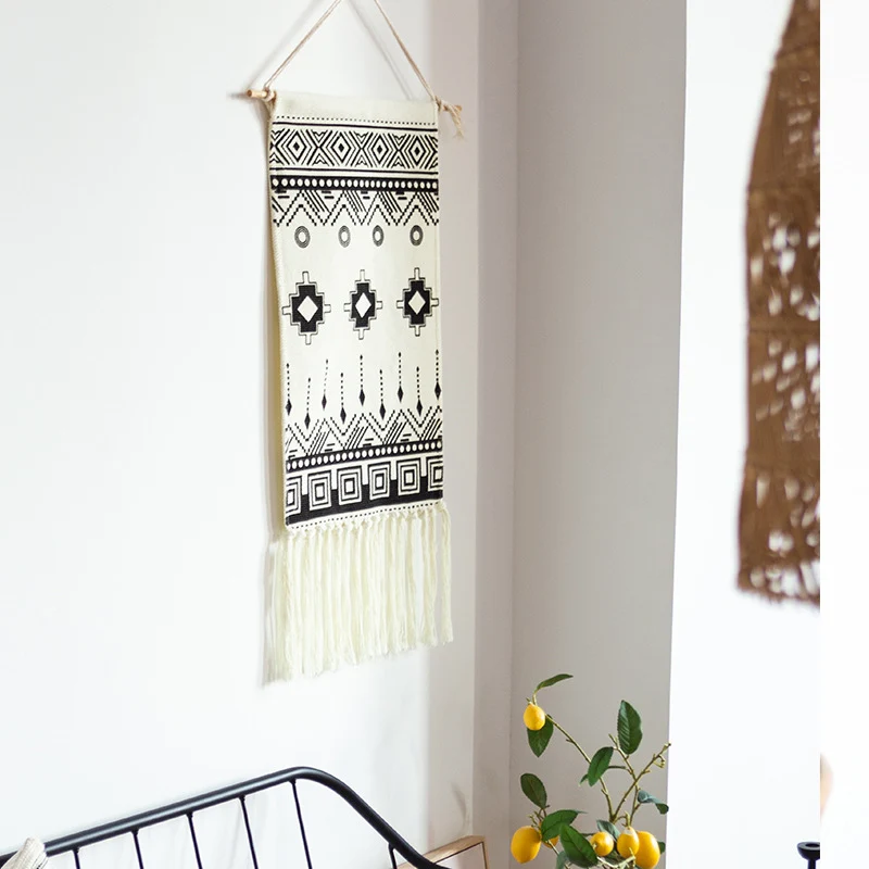 Woven cotton blend wall hanging with graphic ethnic pattern and long fringes Stornfield