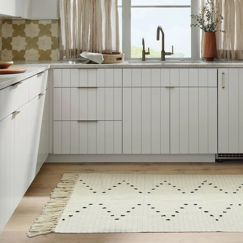 handwoven living room rug with fringes and geometric perforated pattern Stornfield
