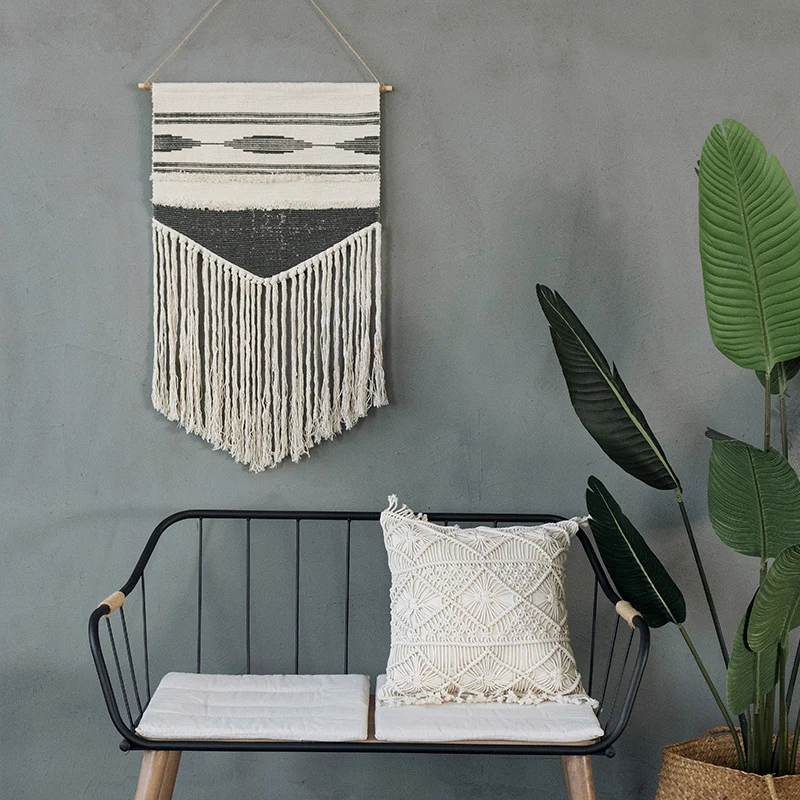 Handwoven wall hanging made of cotton blend with layered textures, wood rod and long fringes Stornfield
