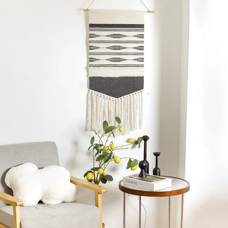 Handwoven wall hanging made of cotton blend with layered textures, wood rod and long fringes Stornfield