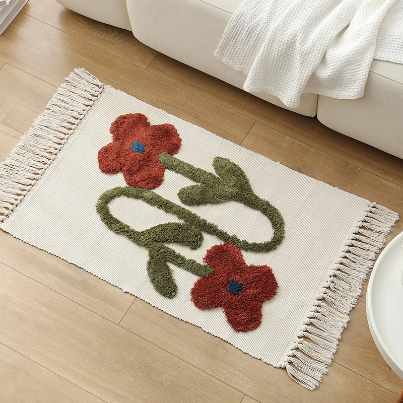 Handwoven cotton bath mat rug with tufted flower appliqué and tassels Stornfield