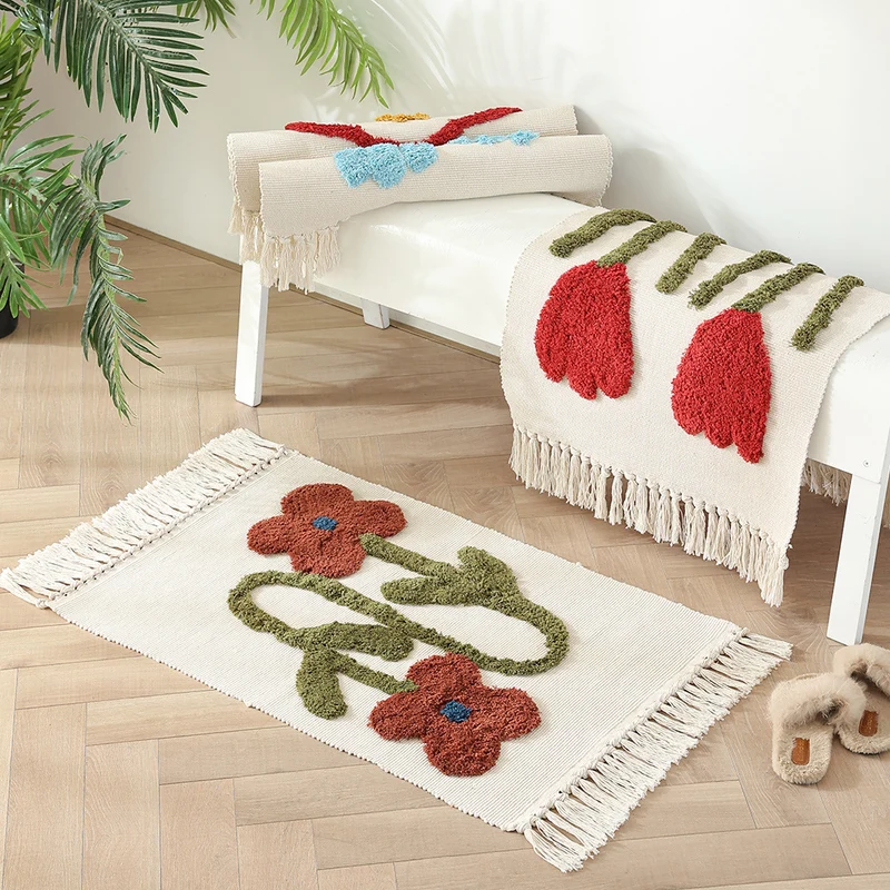 Handwoven cotton bath mat rug with tufted flower appliqué and tassels Stornfield