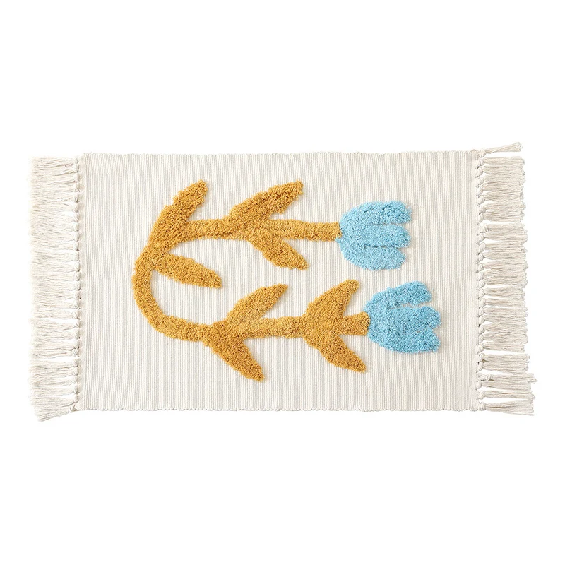 Handwoven cotton bath mat rug with tufted flower appliqué and tassels Stornfield