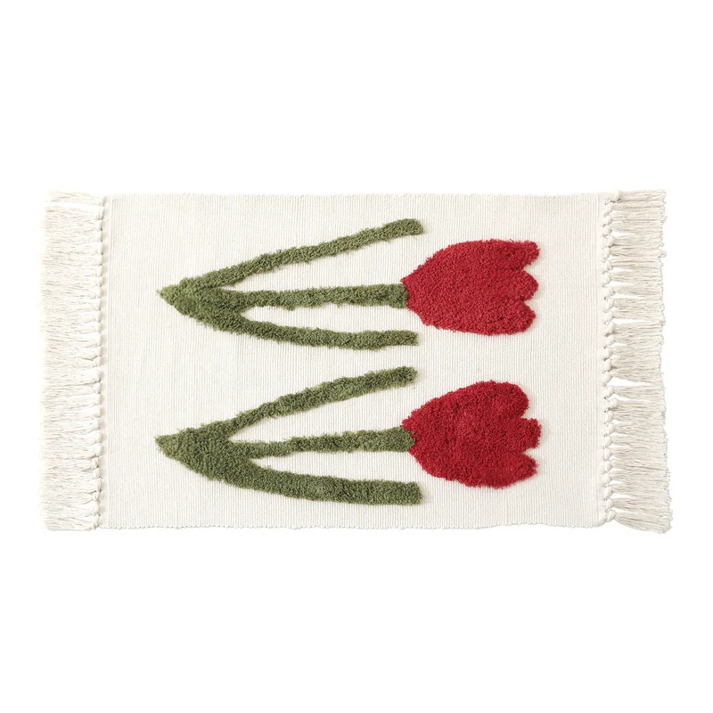 Handwoven cotton bath mat rug with tufted flower appliqué and tassels Stornfield