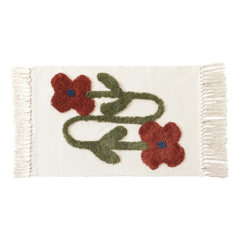 Handwoven cotton bath mat rug with tufted flower appliqué and tassels Stornfield
