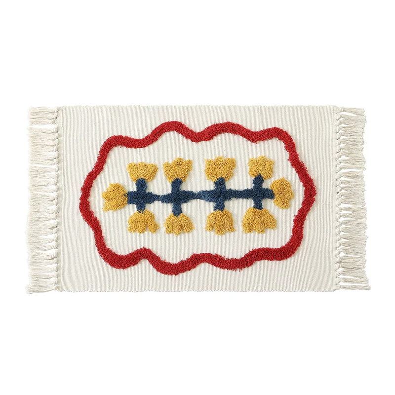 Handwoven cotton bath mat rug with tufted flower appliqué and tassels Stornfield