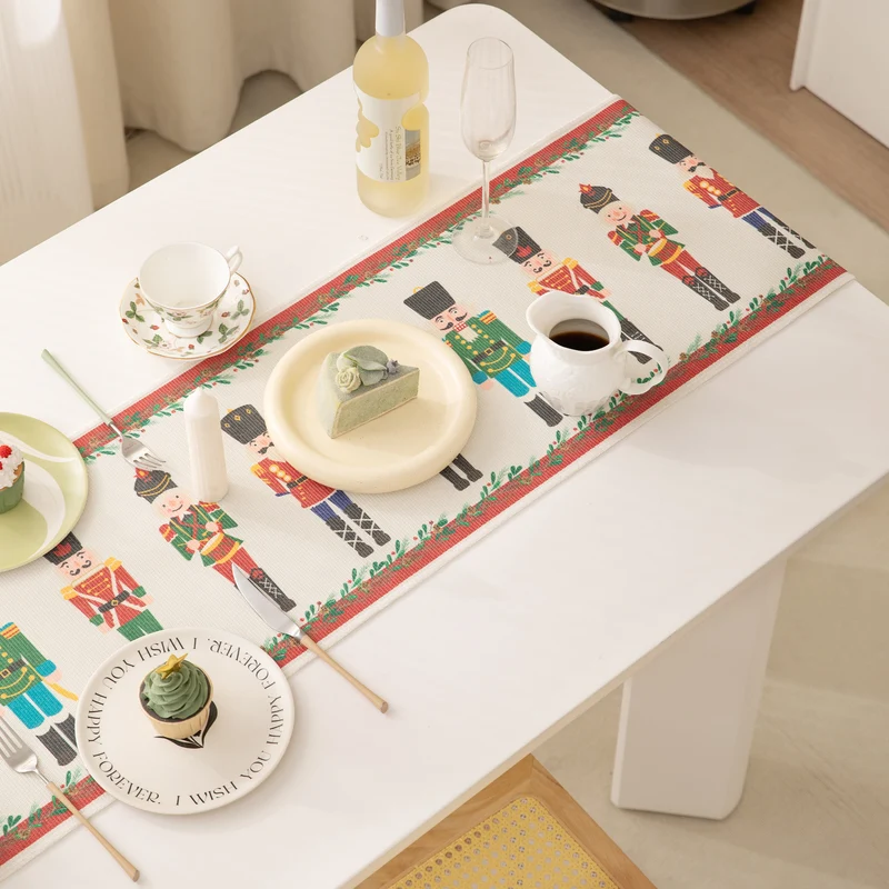 Festive woven table runner with nutcracker motif and golden fringes Stornfield