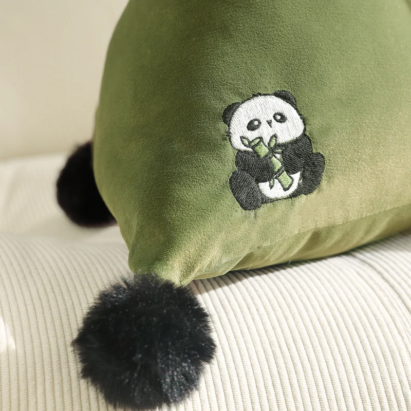 Triangular decorative pillow with zebra embroidery, pompom applications, and soft velvet cover Stornfield