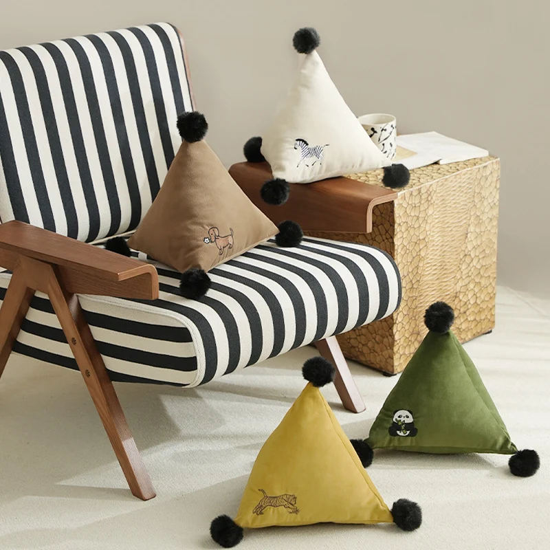 Triangular decorative pillow with zebra embroidery, pompom applications, and soft velvet cover Stornfield
