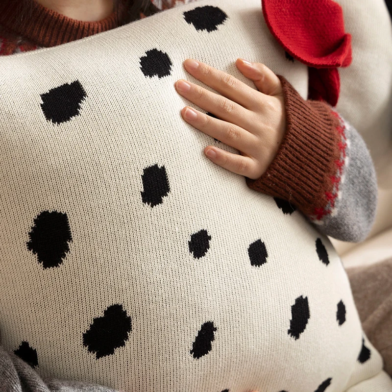 Decorative knitted cuddle pillow in the shape of a dog with a quilted body and bow detail Stornfield