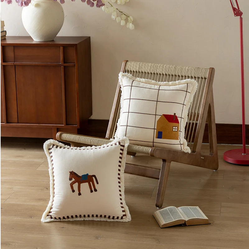 Decorative cushion cover made of cotton blend with fringes, check pattern and embroidered house Stornfield