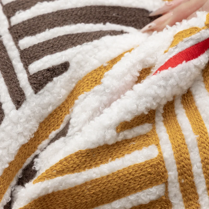 Bouclé pillow with hand-stitched ethnic design and removable cover Stornfield