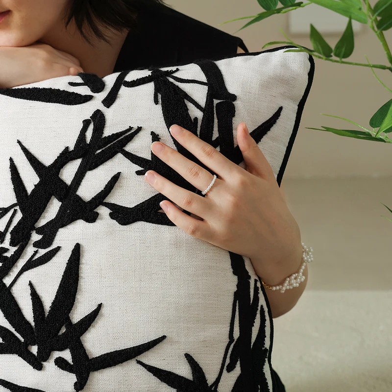 Decorative linen pillow with embroidered bamboo motif Stornfield