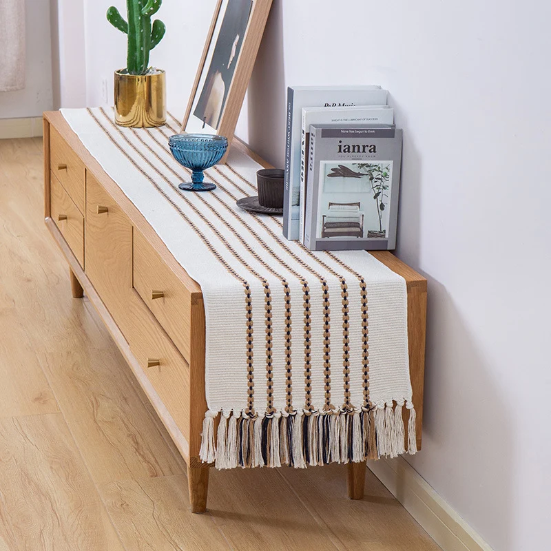Decorative table runner in Scandinavian-minimalist design with macrame fringes Stornfield