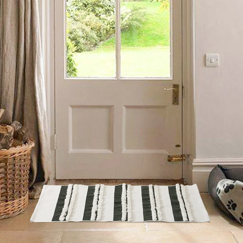 Cotton bath mat with textured stripes and fringes Stornfield
