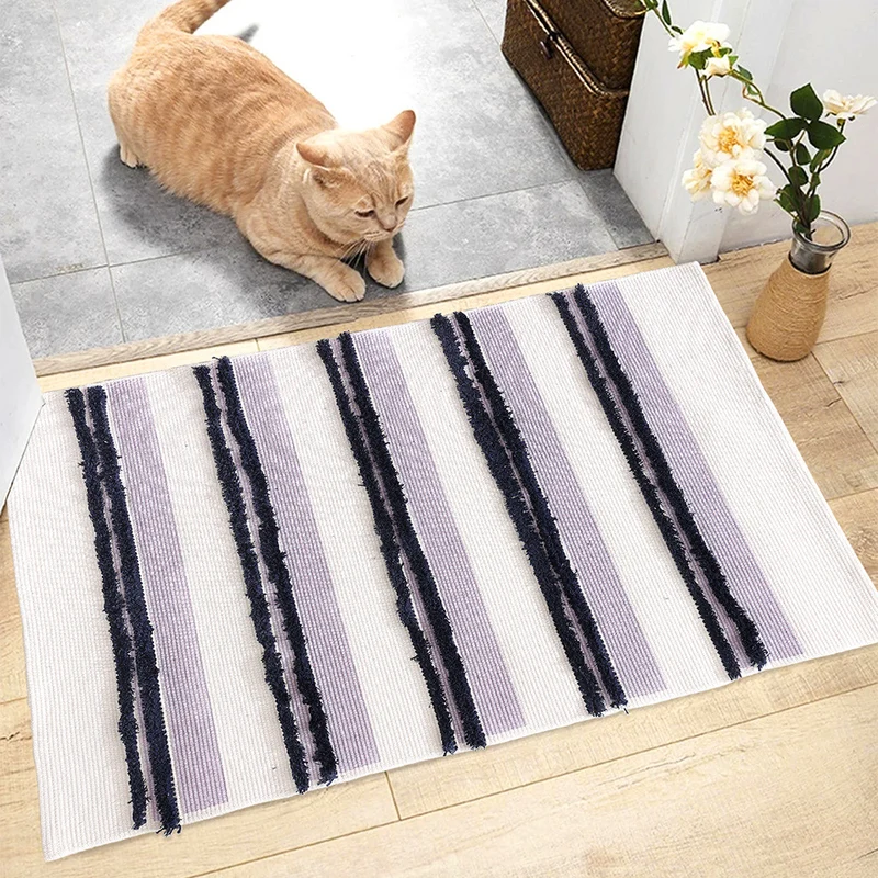 Cotton bath mat with textured stripes and fringes Stornfield
