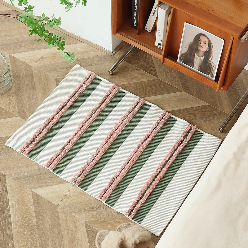 Cotton bath mat with textured stripes and fringes Stornfield
