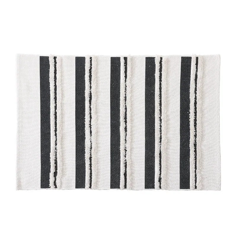 Cotton bath mat with textured stripes and fringes Stornfield