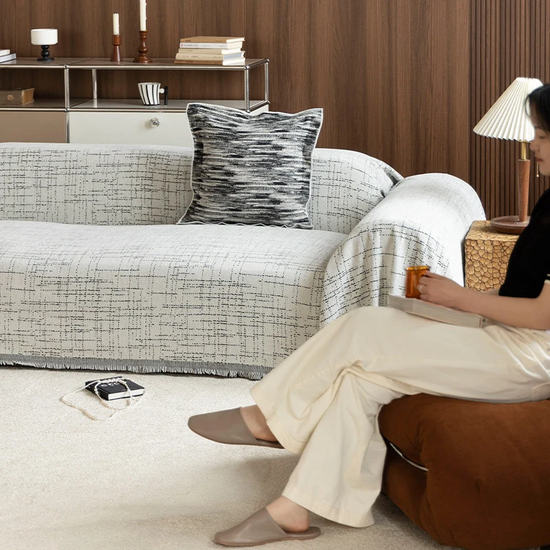 Universal sofa throw made of woven cotton blend with fringes and gentle upholstery cover Stornfield