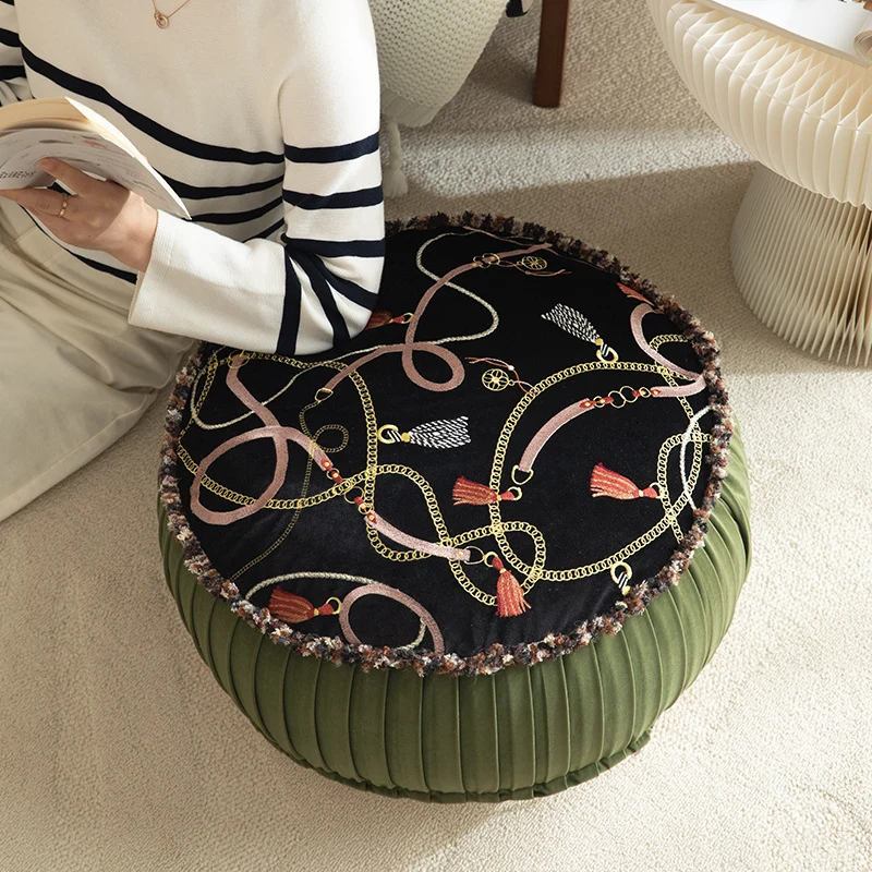 Round decorative floor cushion pouf with velvety printed top, pleated side wall, and fringe edge Stornfield