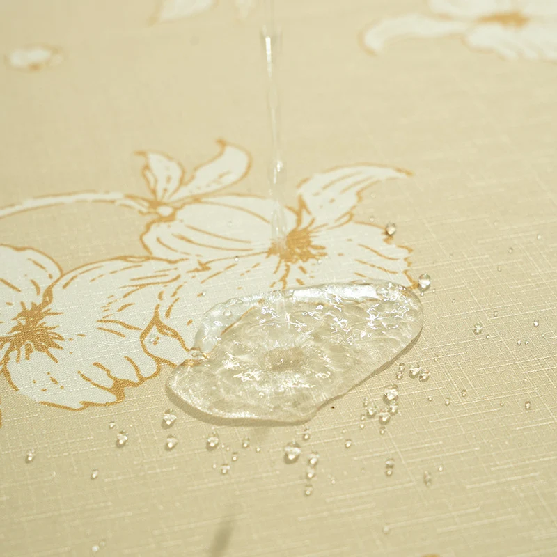 Round wipeable tablecloth with floral cut-out hem Stornfield