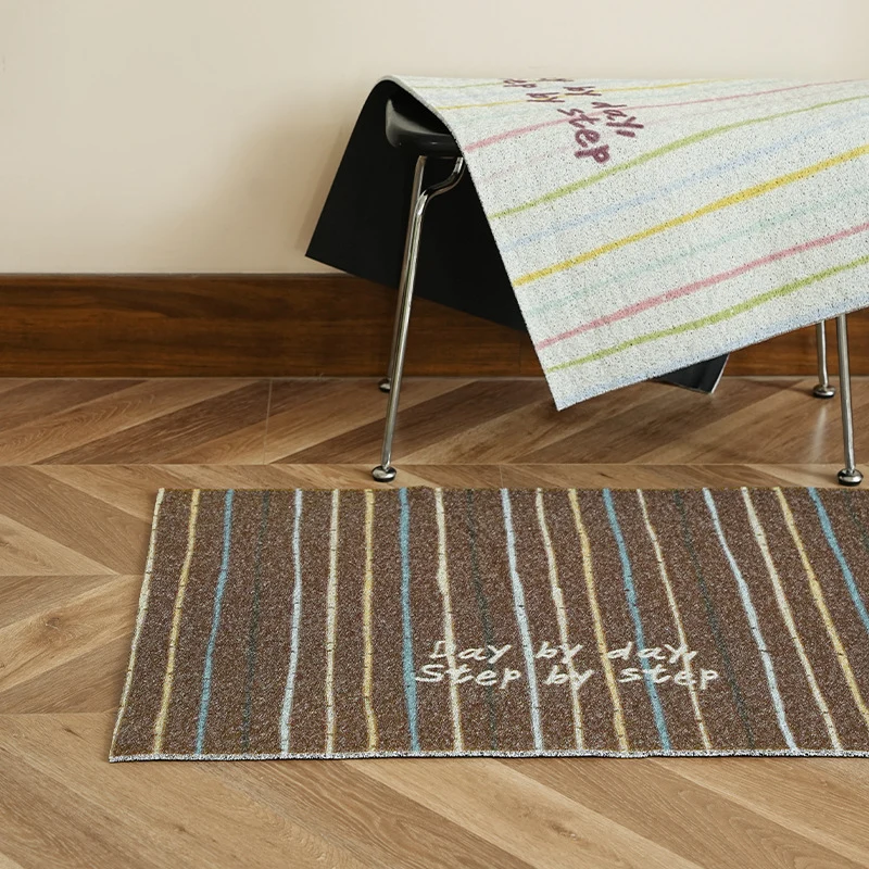 Durable entrance doormat with striped texture and "Welcome" lettering Stornfield