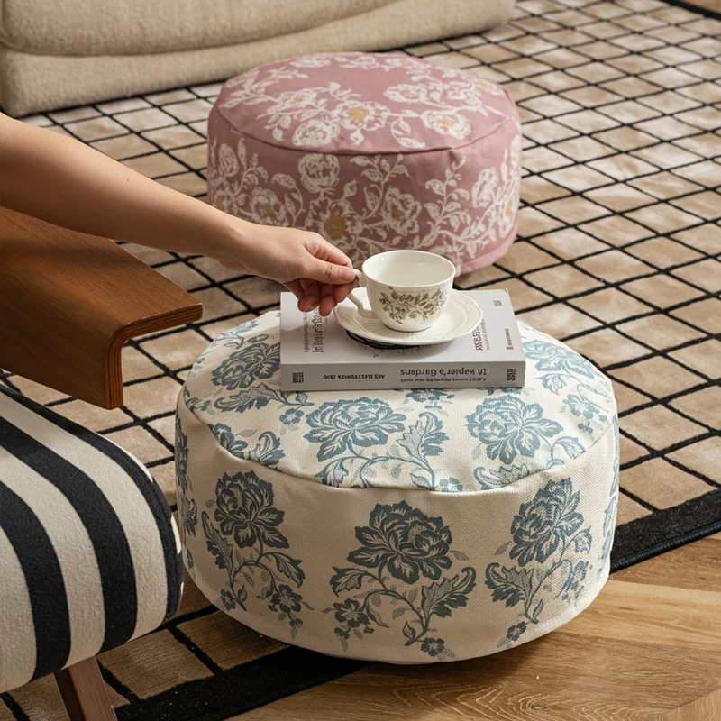 Round seat pouf with floral jacquard weave, stable upholstery core, and carrying handle Stornfield
