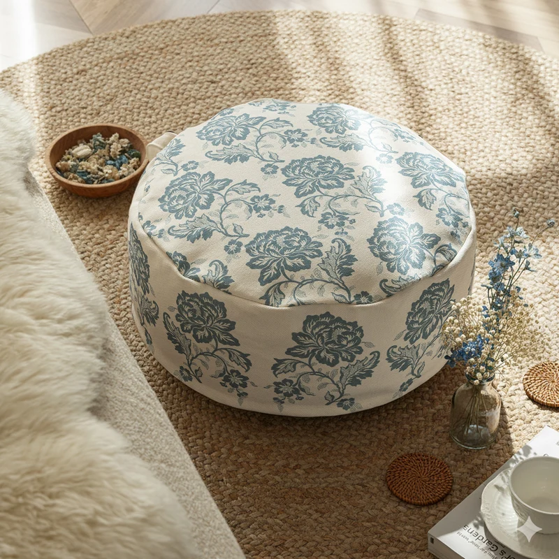 Round seat pouf with floral jacquard weave, stable upholstery core, and carrying handle Stornfield