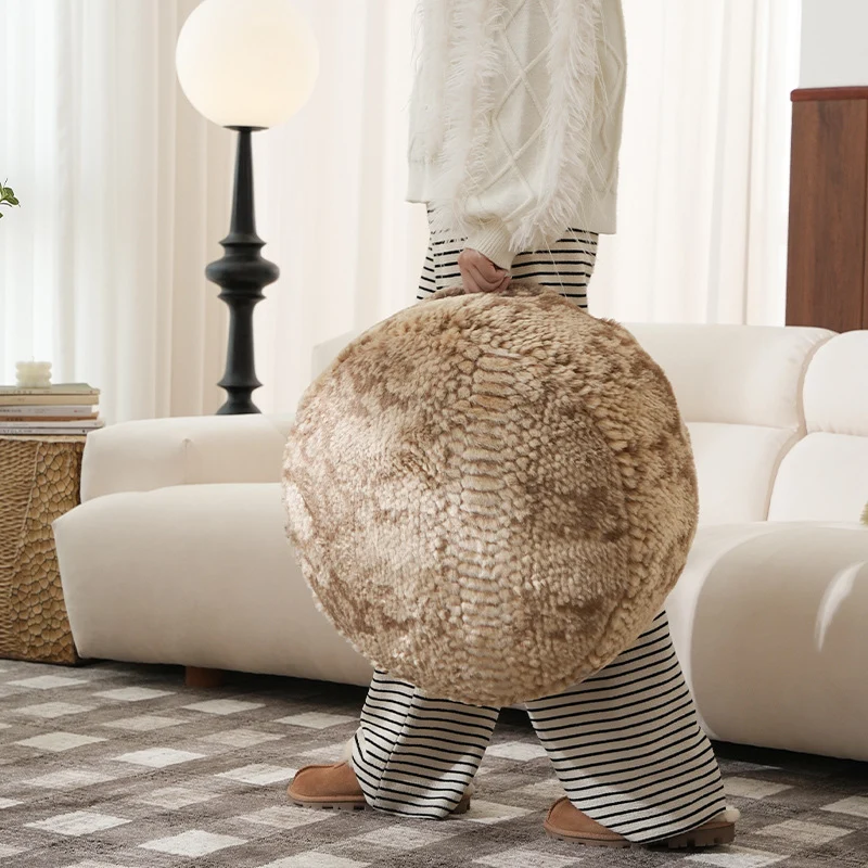 Round seat pouf made of synthetic fur with soft padding and removable cover Stornfield