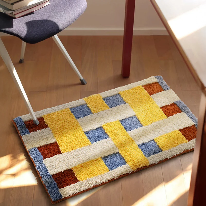 Rectangular tufted door mat with geometric block pattern and non-slip backing Stornfield