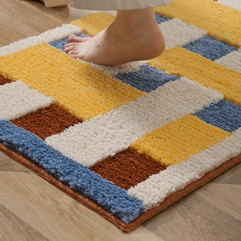 Rectangular tufted door mat with geometric block pattern and non-slip backing Stornfield