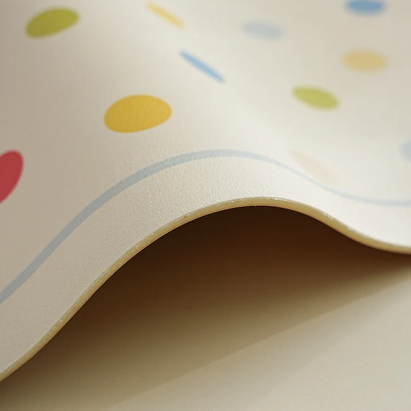 Oval wipeable placemat with pastel-colored polka dots Stornfield