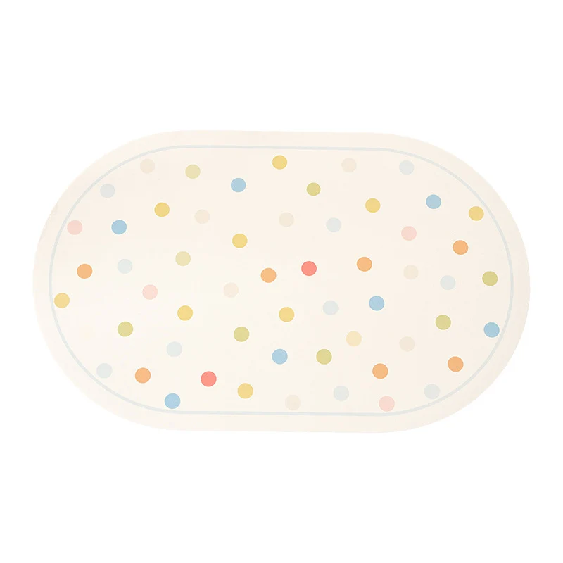 Oval wipeable placemat with pastel-colored polka dots Stornfield