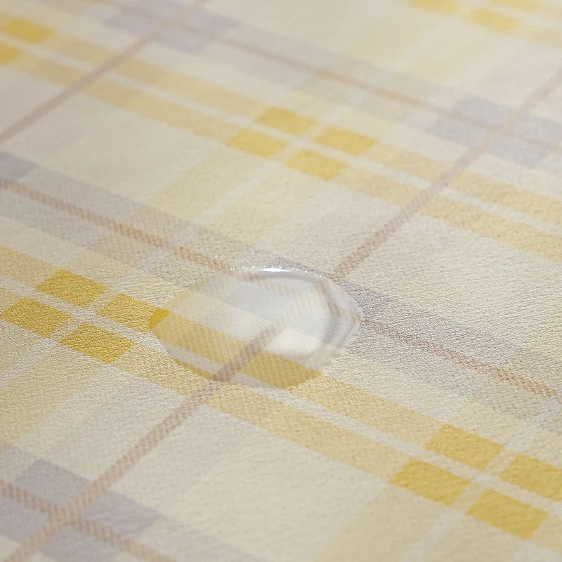 Oval wipeable placemat made of easy-care vinyl with a checked pattern Stornfield