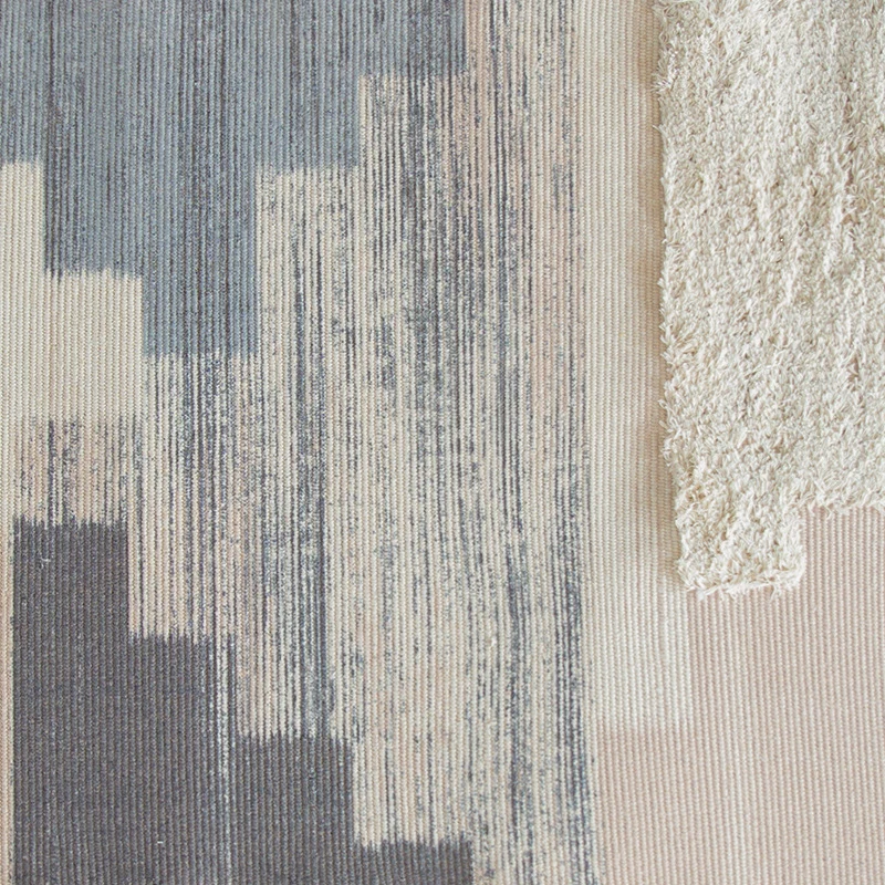 Modern woven living room rug with abstract structure and tufted high-pile accents Stornfield