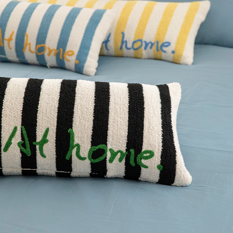 Elongated bench and windowsill cushion with nautical stripe texture and embroidered lettering Stornfield