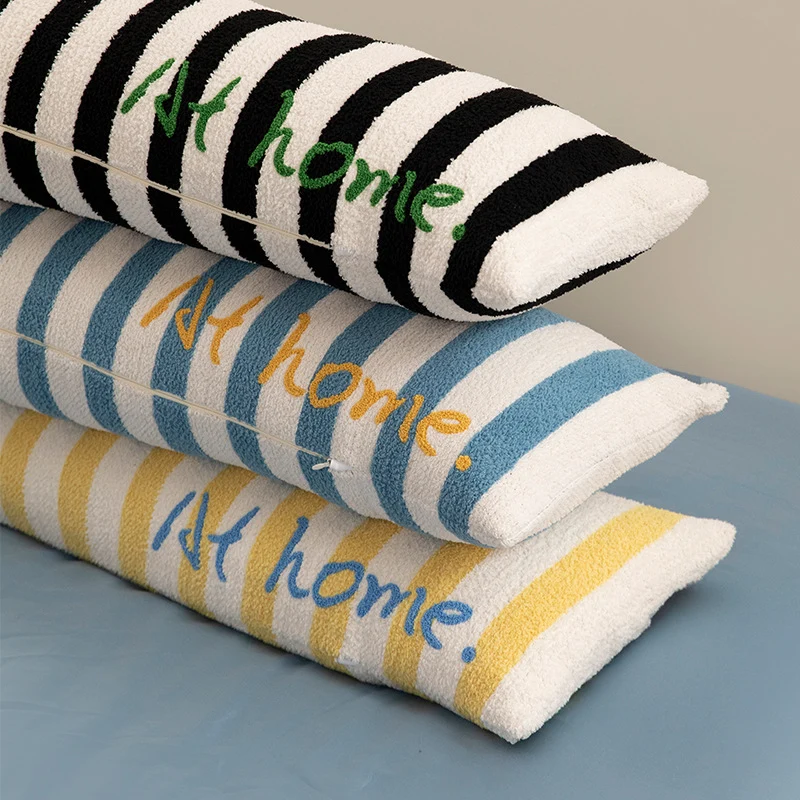 Elongated bench and windowsill cushion with nautical stripe texture and embroidered lettering Stornfield