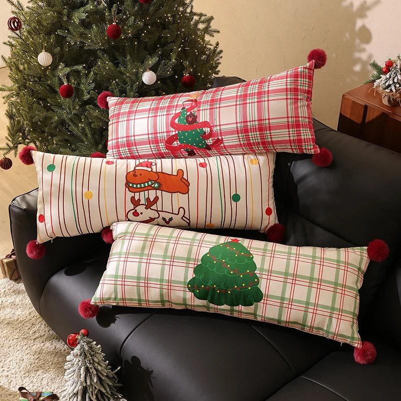 Long decorative lumbar and neck pillow in Christmas check with pompom and dog-tree motif Stornfield