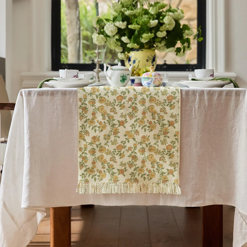 Jacquard table runner with floral vine structure and decorative fringes Stornfield