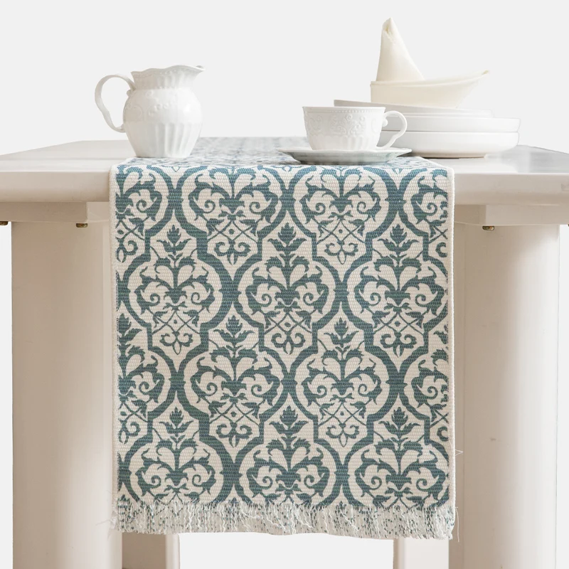 Jacquard table runner with floral vine structure and decorative fringes Stornfield